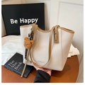 Beige faux leather tote bag with brown trim and cute plush bear charm for women - White