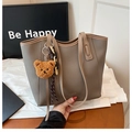 Grey pebbled leather tote bag with brown bear charm and long shoulder straps - Gray