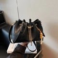 Fashionable black faux leather bucket bag with gold chain and wooden bead charm detail - Black (With Pendant)