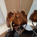 Brown leather bucket bag with gold drawstring chain and beaded vintage pendant detail - Coffee (With Charm)