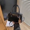 Chic black leather bowling bag with vintage wooden bead charm and crossbody strap - With Charm / Black