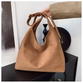 Macro view of high-quality brown suede hobo bag with adjustable metallic strap buckles - Brown
