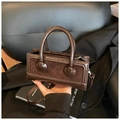 Detail of vintage brown crossbody bag featuring dual-material stitching and metal zipper - Brown