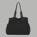 Detail view of large black waterproof nylon tote bag with drawstring and snap pocket - Black