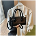 Detail of retro leopard print handbag with black leather handles and silver hardware - Leopard Black