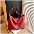 Detail of red pebbled leather hobo bag with texture and stitching details - Red