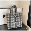 Detail of grey plaid faux shearling tote bag with decorative pearl drawstring closure - Style 1 Plaid / Gray