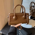 Brown leather and suede patchwork handbag with a circular buckle and top handles - Brown