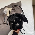 Mini black bucket bag with silver butterfly charms and a large satin bow accent - Black