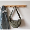 Detail of army green nylon crescent bag with adjustable strap and textured pleats - Yellow