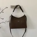 Detailed view of the brown suede hobo bag with adjustable strap and logo patch - Coffee Large
