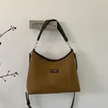Detail of brown faux suede crossbody bag with premium leather trim and dark logo patch - Large / Yellow Brown