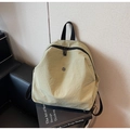 Detailed macro view of olive green nylon fabric texture and round metal logo on backpack - Green