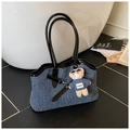 Detail of blue denim tote bag with black leather trim and a cute teddy bear charm - With Pendant / Brown