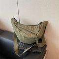 Olive green half-moon crossbody bag with woven zipper pullers and wide nylon strap - Green
