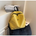 Bright yellow lightweight nylon backpack with black straps in a casual lifestyle setting - Yellow