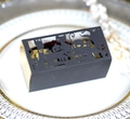 Detail of laser-cut Halloween gift box with black pumpkin and castle motifs on a plate - Black Khaki