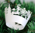 Intricate laser-cut white Christmas cupcake liners with snowflake and reindeer patterns - White