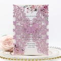 Detail of pink glitter laser-cut butterfly invitation with floral insert and gold-rimmed plate - Light Purple