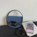 Retro denim and black leather saddle bag featuring a top handle and adjustable strap - Black