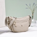 Detail of beige waterproof nylon crossbody bag with multi-pocket design and adjustable strap - Khaki