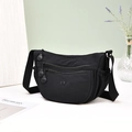 Detail of black waterproof nylon crescent bag with multiple zipper pockets and adjustable strap - Black