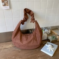 Detail of dark brown faux suede hobo bag with ruffled handle and drawstring texture - Brown