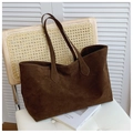Close-up of a large dark brown suede tote bag placed on a vintage rattan wooden chair - Brown