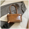 Macro detail of glossy brown vintage faux leather tote bag with stylish buckle strap - Brown No Pendant