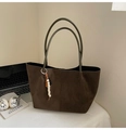Detail of a large brown suede tote bag with slim green handles and a beaded charm accessory - Green with Pendant