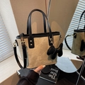 Beige suede bucket bag with black leather trim and cute puppy charm accessory - Cream White With Pendant