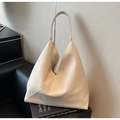 Detail shot of a minimalist cream tote bag with diagonal stitching on a textured chair - Off-white