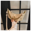 Detail of oatmeal suede crescent bag featuring a gold chain strap and knot handle design - Khaki