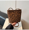 Detailed view of leopard print faux suede bucket bag with dark brown leather ring handle - Leopard Print