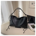 Close-up of retro black tote bag with woven handles and lace-up side details - Black