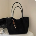 Large black suede tote bag with beaded tassel charm on a minimalist desk setup - Black with Pendant