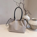 Minimalist beige drawstring tote bag with black handles in a stylish aesthetic setting - Gray
