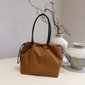 Caramel drawstring tote bag with black leather handles for stylish daily commuting - Brown