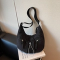 Chic black pleated dumpling crossbody bag with adjustable strap and dual front pockets - Black