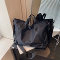 Große schwarze Nylon-Reisetasche mit Doppelgriffen und verstellbarem Schultergurt - Schwarz