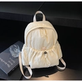 Close-up of cream backpack with bubble textured fabric and drawstring front pocket - Off White