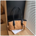 Detailed close-up of brown quilted faux suede tote bag with vintage bead pendant - Brown with Pendant