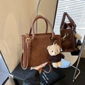 Vintage brown leather handbag with teddy bear charm and HOCOMU logo detail - With Pendant / Brown