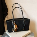Black quilted tote bag with bead tassel detail on books for autumn fashion - Black with Pendant