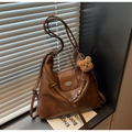 Vintage brown leather tote bag with a cute plush bear charm in a lifestyle setting - Brown with Pendant