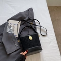 Quilted black bucket bag in suede and faux leather with gold buckle on white bedding - Black without Pendant
