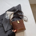 Brown quilted bucket bag in suede and leather with gold lock and shoulder strap - Coffee No Charm