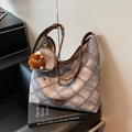 Grey quilted denim hobo bag with brown leather strap and lion charm accessory - Gray