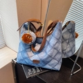 Blue denim pattern patchwork tote bag with brown leather strap and monster charm accessory - Blue