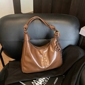 Retro brown hobo bag in glossy leather featuring a large knotted strap and metal charm - Brown (With Pendant)
